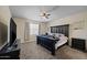 Bedroom with a full bed, dark wood furniture, carpet flooring, and a television at 36412 W Pampoloma Ave, Maricopa, AZ 85138