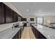Modern kitchen with stainless steel appliances, granite counters, and an island with a sink at 36412 W Pampoloma Ave, Maricopa, AZ 85138
