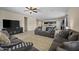 Spacious living room featuring tile floors, a ceiling fan, and an open floor plan into the kitchen at 36412 W Pampoloma Ave, Maricopa, AZ 85138