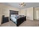 Large main bedroom with a king-sized bed, carpet flooring, and neutral walls at 36412 W Pampoloma Ave, Maricopa, AZ 85138