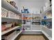 Walk-in pantry with abundant shelving for optimal storage at 36412 W Pampoloma Ave, Maricopa, AZ 85138