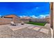 Spacious backyard featuring a paver patio and a small patch of lush green grass at 39985 W Rio Lobo Dr, Maricopa, AZ 85138