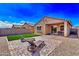 Relaxing backyard with lounge chairs, a paver patio, and a small turf area at 39985 W Rio Lobo Dr, Maricopa, AZ 85138