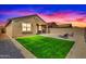 Large backyard featuring a green lawn, paver patio, lounge chairs, and BBQ at 39985 W Rio Lobo Dr, Maricopa, AZ 85138