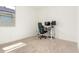 Bright bedroom with a large window and a desk setup for working from home at 39985 W Rio Lobo Dr, Maricopa, AZ 85138