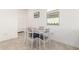 Bright dining area featuring a modern table with seating for four near a window at 39985 W Rio Lobo Dr, Maricopa, AZ 85138