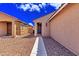Inviting front entrance with a walkway leading to a dark-stained front door at 39985 W Rio Lobo Dr, Maricopa, AZ 85138