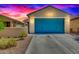 Charming single-story home with a two-car garage and a colorful blue door at 39985 W Rio Lobo Dr, Maricopa, AZ 85138