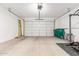Spacious garage featuring ample room for storage or fitness, with its epoxy flooring and tall ceilings at 39985 W Rio Lobo Dr, Maricopa, AZ 85138