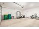 Spacious garage featuring ample room for storage or fitness, with its epoxy flooring and tall ceilings at 39985 W Rio Lobo Dr, Maricopa, AZ 85138