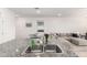 Close-up of the kitchen featuring a double stainless steel sink and granite countertops at 39985 W Rio Lobo Dr, Maricopa, AZ 85138