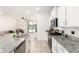 Open kitchen design with granite counters, stainless steel appliances, and seamless access to living area at 39985 W Rio Lobo Dr, Maricopa, AZ 85138