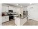Well-lit kitchen featuring granite countertops, stainless steel appliances, and a functional island at 39985 W Rio Lobo Dr, Maricopa, AZ 85138