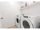 Bright laundry room with a washer and dryer, offering convenience for everyday living at 39985 W Rio Lobo Dr, Maricopa, AZ 85138