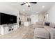Spacious living room with an open layout, seamlessly connects to the kitchen with an island at 39985 W Rio Lobo Dr, Maricopa, AZ 85138