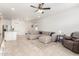 Open-concept living space features neutral colors, tile flooring, and comfortable seating at 39985 W Rio Lobo Dr, Maricopa, AZ 85138