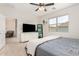 Main bedroom with a queen bed, TV, and a view into the main bathroom at 39985 W Rio Lobo Dr, Maricopa, AZ 85138