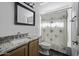 Bathroom featuring granite counters, framed mirror and floral shower curtain at 4530 E Desert Wind Dr, Phoenix, AZ 85044