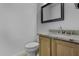 Cozy half-bath with granite countertop vanity and framed mirror for guests' convenience at 4530 E Desert Wind Dr, Phoenix, AZ 85044