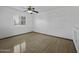 A bright bedroom offers hardwood flooring, ceiling fan, and plantation shutters at 4530 E Desert Wind Dr, Phoenix, AZ 85044