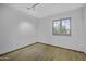 This is a bright bedroom with a window and hardwood floors at 4530 E Desert Wind Dr, Phoenix, AZ 85044