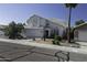 Charming two-story home with a white exterior, a two car garage and desert landscaping at 4530 E Desert Wind Dr, Phoenix, AZ 85044