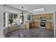 Kitchen with stainless steel appliances, wooden cabinets, granite countertops, and a breakfast nook at 4530 E Desert Wind Dr, Phoenix, AZ 85044