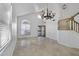 Bright and airy living room featuring tile floors, a chandelier, and large arched window at 4530 E Desert Wind Dr, Phoenix, AZ 85044