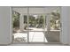 A covered patio offers an outside living space with desert landscaping viewed through sliding glass doors at 4530 E Desert Wind Dr, Phoenix, AZ 85044