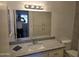 Bathroom features a vanity with granite countertop and a large mirror at 461 W Holmes Ave # 360, Mesa, AZ 85210