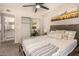Bright bedroom featuring a ceiling fan, a painting, and closet with mirrored doors at 461 W Holmes Ave # 360, Mesa, AZ 85210