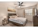 Sunlit bedroom featuring a ceiling fan, a large window, and contemporary decor at 461 W Holmes Ave # 360, Mesa, AZ 85210