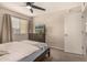 Bedroom featuring a ceiling fan, a window with blinds, and a dresser with TV at 461 W Holmes Ave # 360, Mesa, AZ 85210