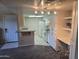 Well-lit kitchen featuring white cabinets, granite countertops, and modern appliances with carpeted living space at 461 W Holmes Ave # 360, Mesa, AZ 85210