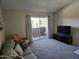 Bright living room with plush carpet and a sliding door to the balcony for natural light at 461 W Holmes Ave # 360, Mesa, AZ 85210
