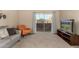 Bright living room with comfortable seating and sliding glass doors to balcony at 461 W Holmes Ave # 360, Mesa, AZ 85210