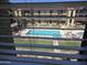 View of a community pool from inside the home, seen through window blinds at 461 W Holmes Ave # 360, Mesa, AZ 85210