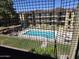 Exterior view of a community pool from the home with building in background at 461 W Holmes Ave # 360, Mesa, AZ 85210