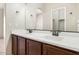 Bathroom with double vanity sinks, a spacious mirror, and warm neutral colors at 4716 E Red Oak Ln # 102, Gilbert, AZ 85297