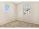 Neutral bedroom with carpet, two windows, and light, neutral-colored walls at 4716 E Red Oak Ln # 102, Gilbert, AZ 85297