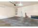 Spacious garage with concrete floor, laundry area, and water heater at 4716 E Red Oak Ln # 102, Gilbert, AZ 85297