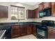 This kitchen features dark cabinetry, stainless steel appliances, and granite countertops at 4716 E Red Oak Ln # 102, Gilbert, AZ 85297