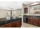This kitchen features dark cabinetry, stainless steel appliances, and granite countertops at 4716 E Red Oak Ln # 102, Gilbert, AZ 85297