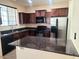 This kitchen has stainless steel refrigerator, dark cabinetry, and granite countertops at 4716 E Red Oak Ln # 102, Gilbert, AZ 85297