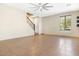 Bright, open-concept living room with neutral walls, tile flooring, and a ceiling fan at 4716 E Red Oak Ln # 102, Gilbert, AZ 85297