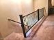 Carpeted staircase with black metal railing leading to the lower level of the home at 4716 E Red Oak Ln # 102, Gilbert, AZ 85297