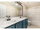 Bathroom features a double sink vanity with black matte faucets and a shower-tub combo at 4801 E Quien Sabe Way, Cave Creek, AZ 85331