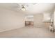 Spacious carpeted bedroom area with a ceiling fan and staircase with wood railing visible at 4801 E Quien Sabe Way, Cave Creek, AZ 85331