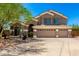 Stunning two-story home featuring a spacious three-car garage and beautifully landscaped front yard at 4801 E Quien Sabe Way, Cave Creek, AZ 85331