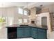 Open concept kitchen with central island, views of the Gathering room, and a fireplace at 4801 E Quien Sabe Way, Cave Creek, AZ 85331